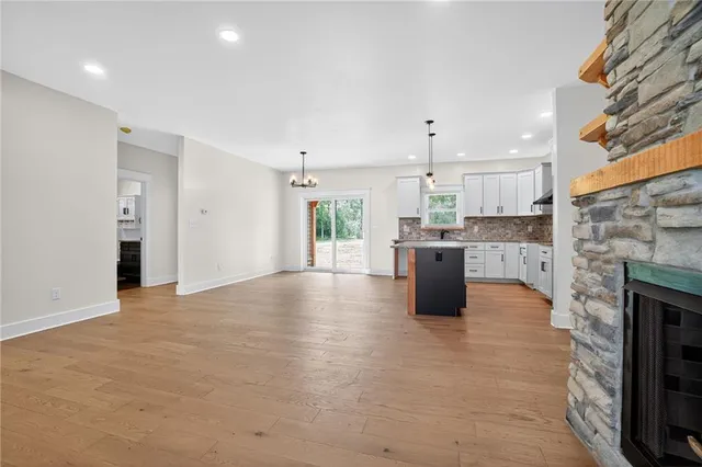 a kitchen with stainless steel appliances a refrigerator and a fireplace