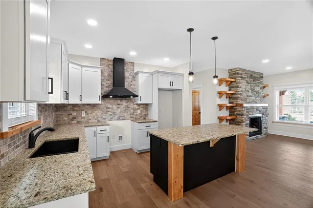 a kitchen with stainless steel appliances granite countertop wooden cabinets a sink and dishwasher