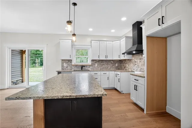 a kitchen with stainless steel appliances granite countertop sink stove top oven and cabinets