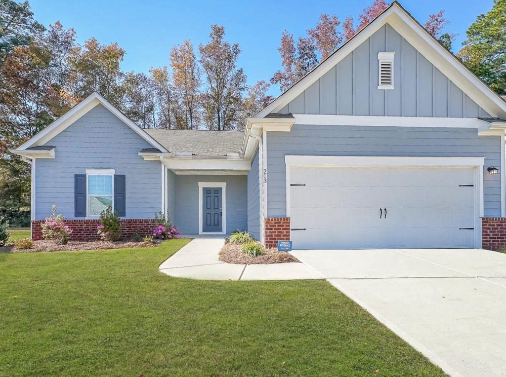 213 Cottontail Lane Villa Rica, GA 30180 - Photo 1 of 1 a front view of a house with a yard and garage