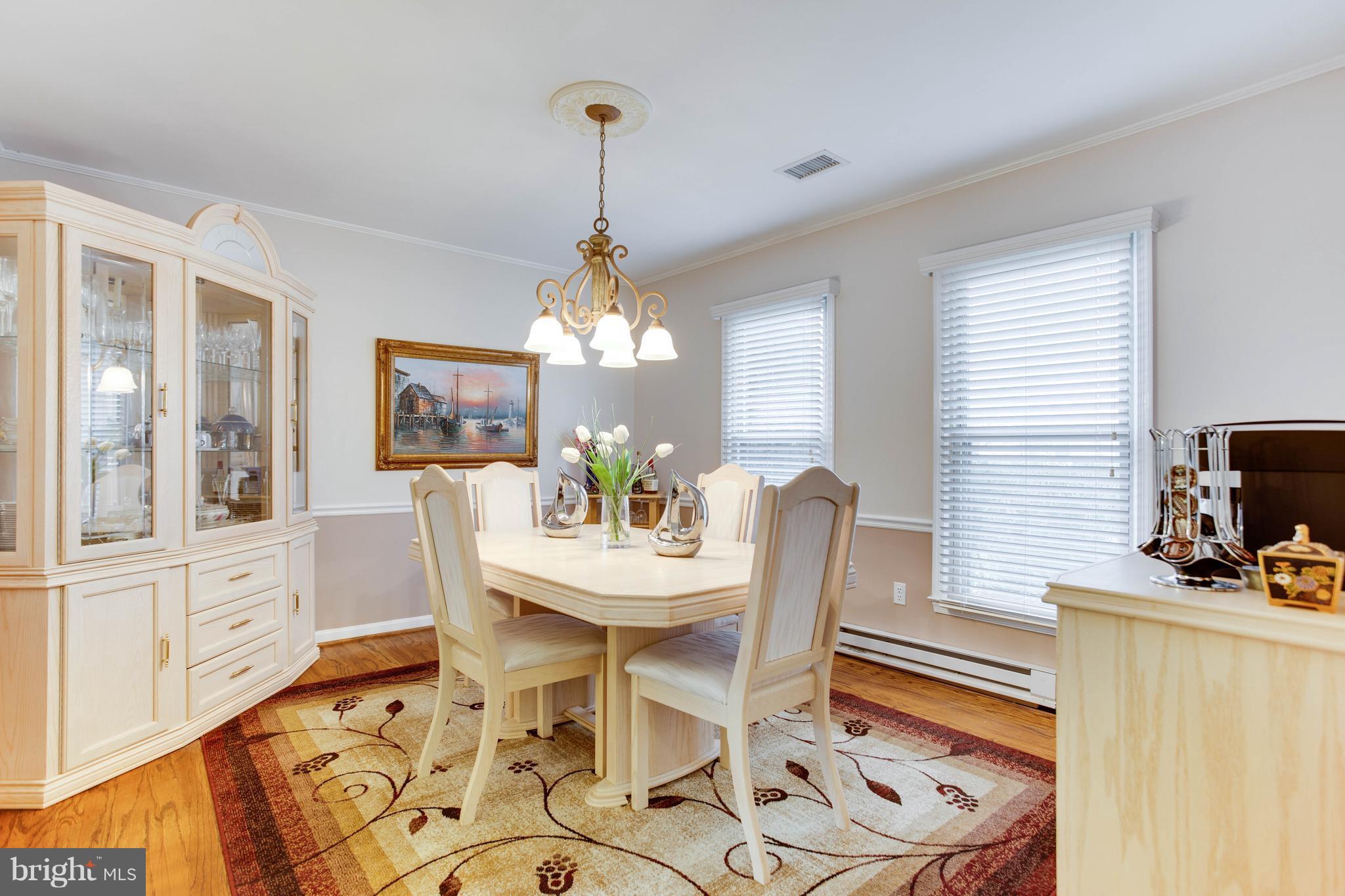 11633 Rivershore Drive Dunkirk, MD 20754 - Photo 13 of 29 a view of a dining room with furniture a chandelier and wooden floor