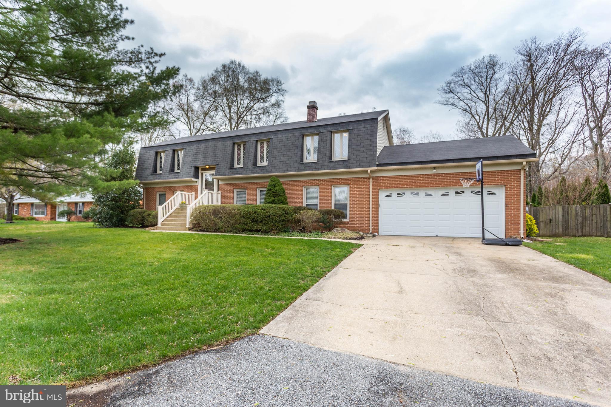 11633 Rivershore Drive Dunkirk, MD 20754 - Photo 8 of 29 a front view of a house with a garden and trees