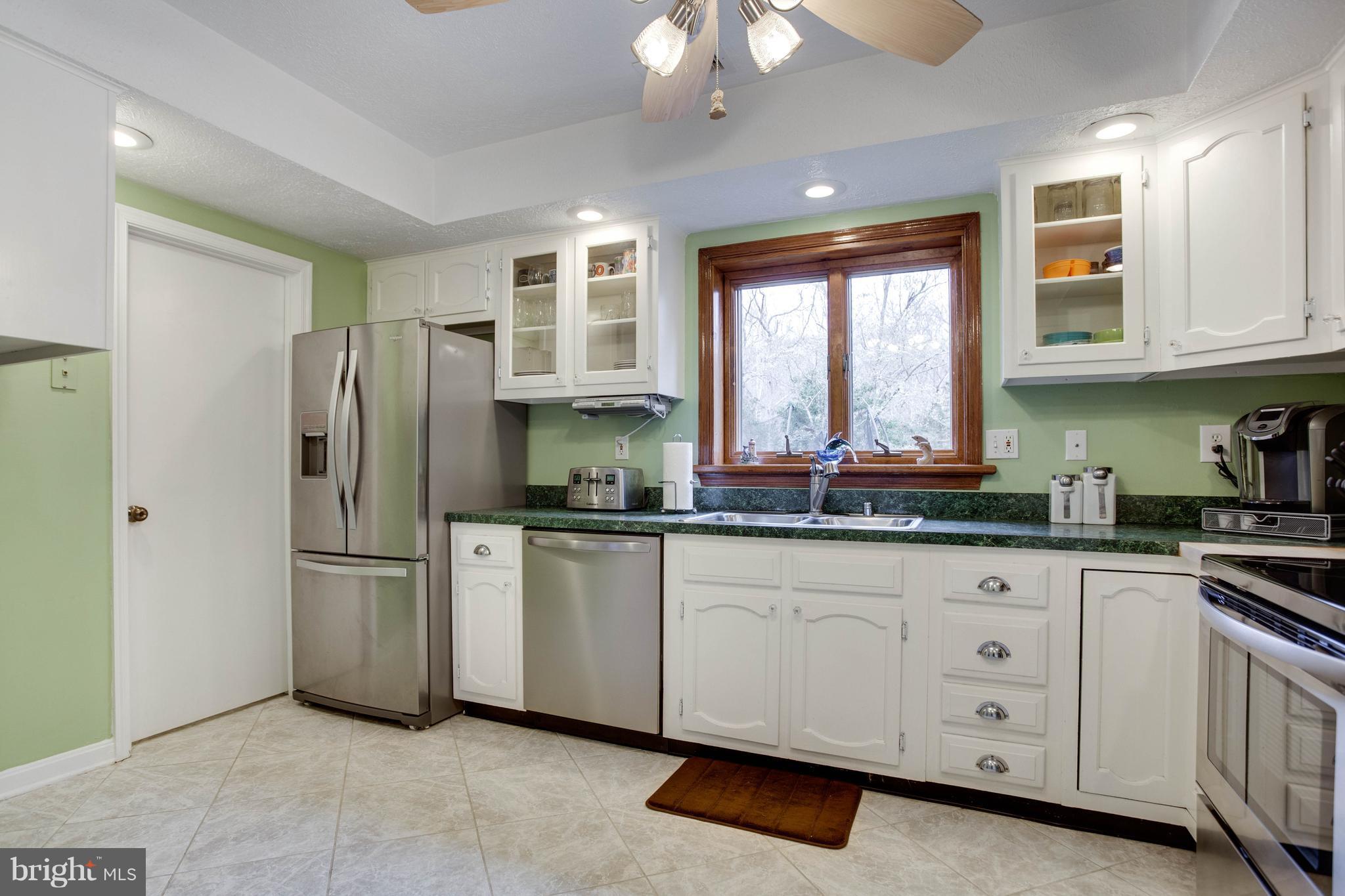 11633 Rivershore Drive Dunkirk, MD 20754 - Photo 9 of 29 a kitchen with granite countertop a sink stainless steel appliances and window