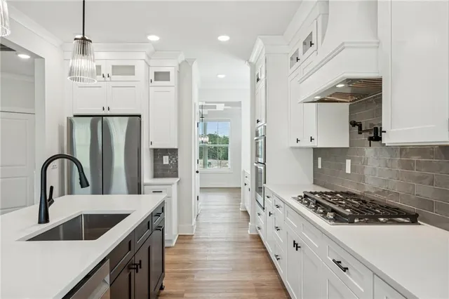 a kitchen with kitchen island a sink a stove and chairs