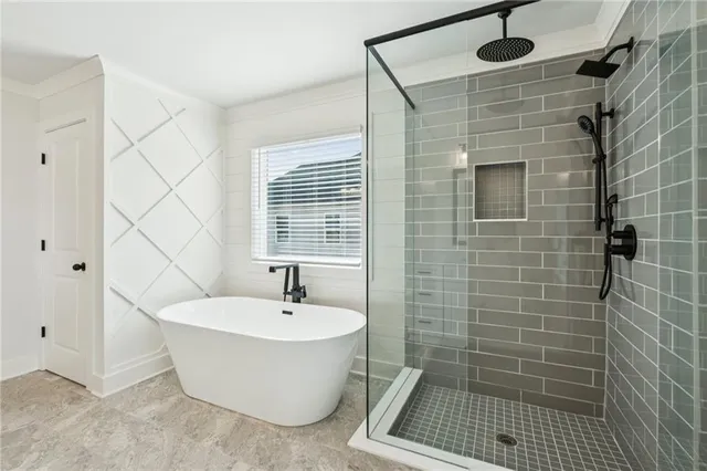 a white bath tub sitting next to a white sink