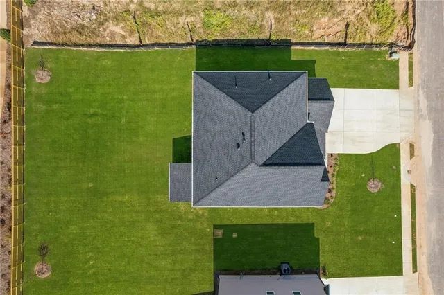 a aerial view of a house with a backyard