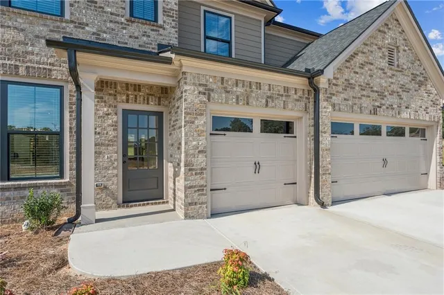 a view of a hallway with wooden floor and entryway