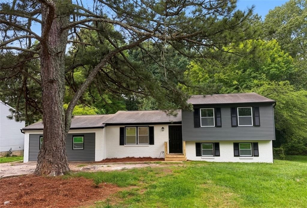 6855 Kimberly Mill Road Atlanta, GA 30349 - Photo 1 of 11 a front view of a house with a yard