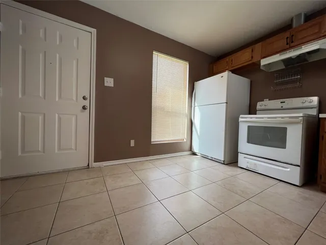 a view of a kitchen with a sink and a stove top oven