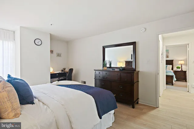 a bathroom with a granite countertop sink a toilet and a mirror