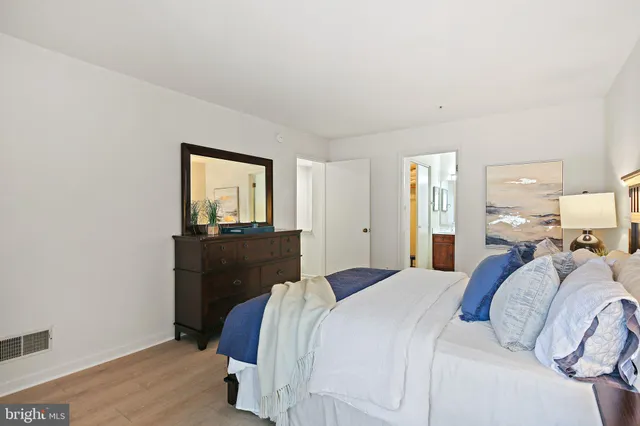 a bathroom with a painting on the wall and a shower