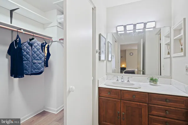 a bed sitting in a bedroom next to a window and a wooden floor