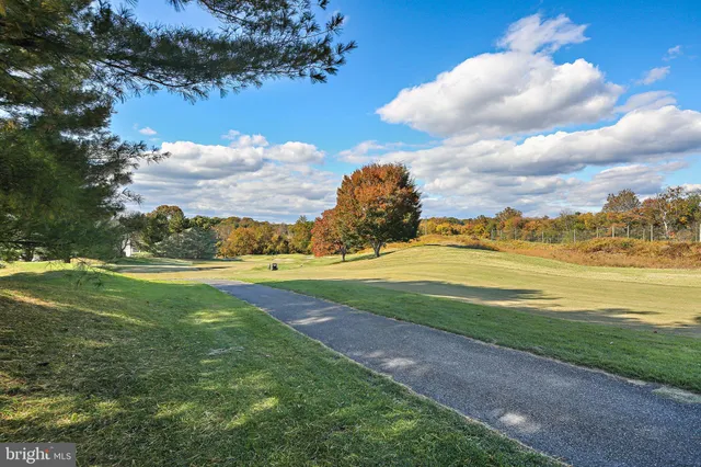 a sign that is sitting in the middle of a garden