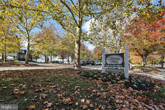 a group of people sitting in a yard in front of a house