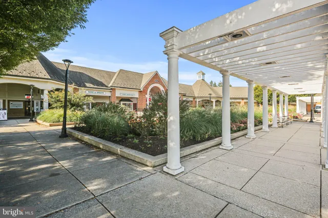 a front view of a house with a yard garage and fountain