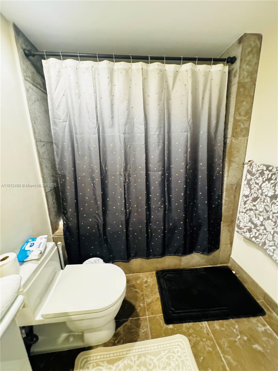 475 Brickell Avenue, Unit 808 Miami, FL 33131 - Photo 11 of 19 a bathroom with a bathtub and shower