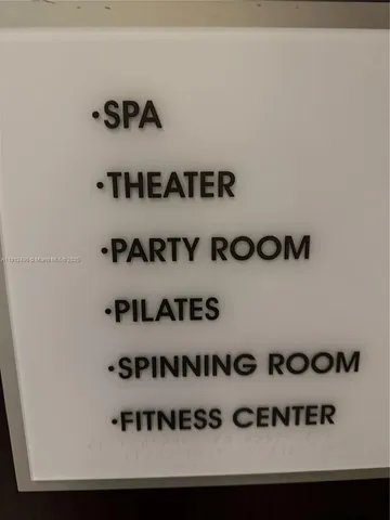 a view of a room with a white wall and curtain