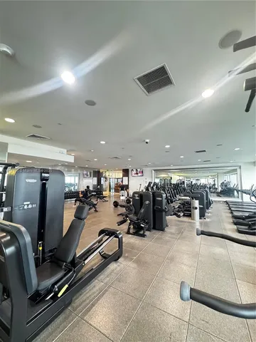 a room with gym equipment and a large window