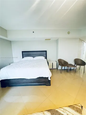 a bedroom with a bed and a night stand