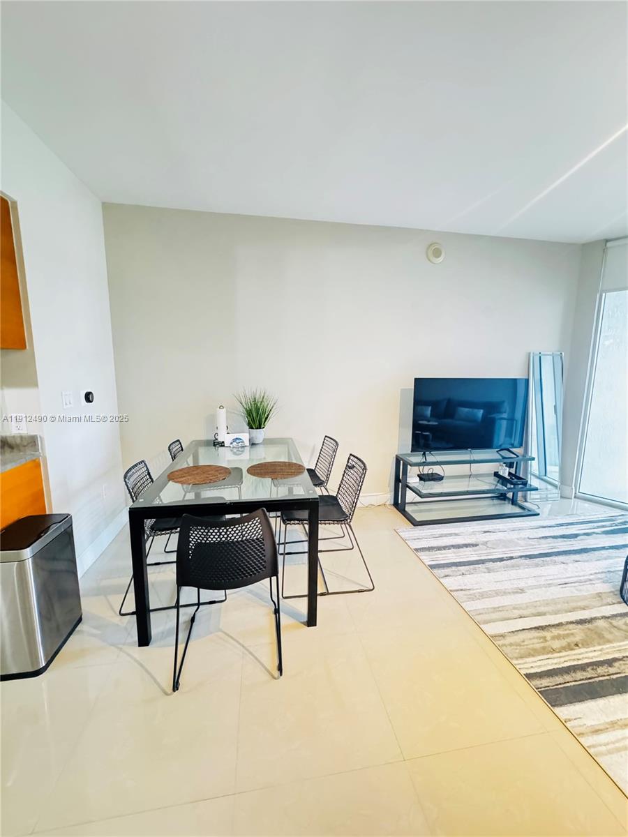 475 Brickell Avenue, Unit 808 Miami, FL 33131 - Photo 4 of 19 a living room with furniture and a flat screen tv