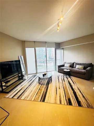 a bed sitting in a room next to a window