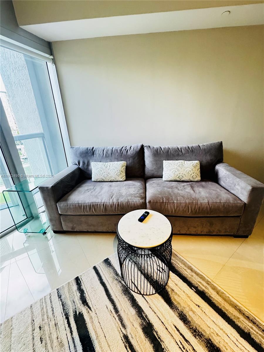 475 Brickell Avenue, Unit 808 Miami, FL 33131 - Photo 6 of 19 a living room with furniture and a wooden floor