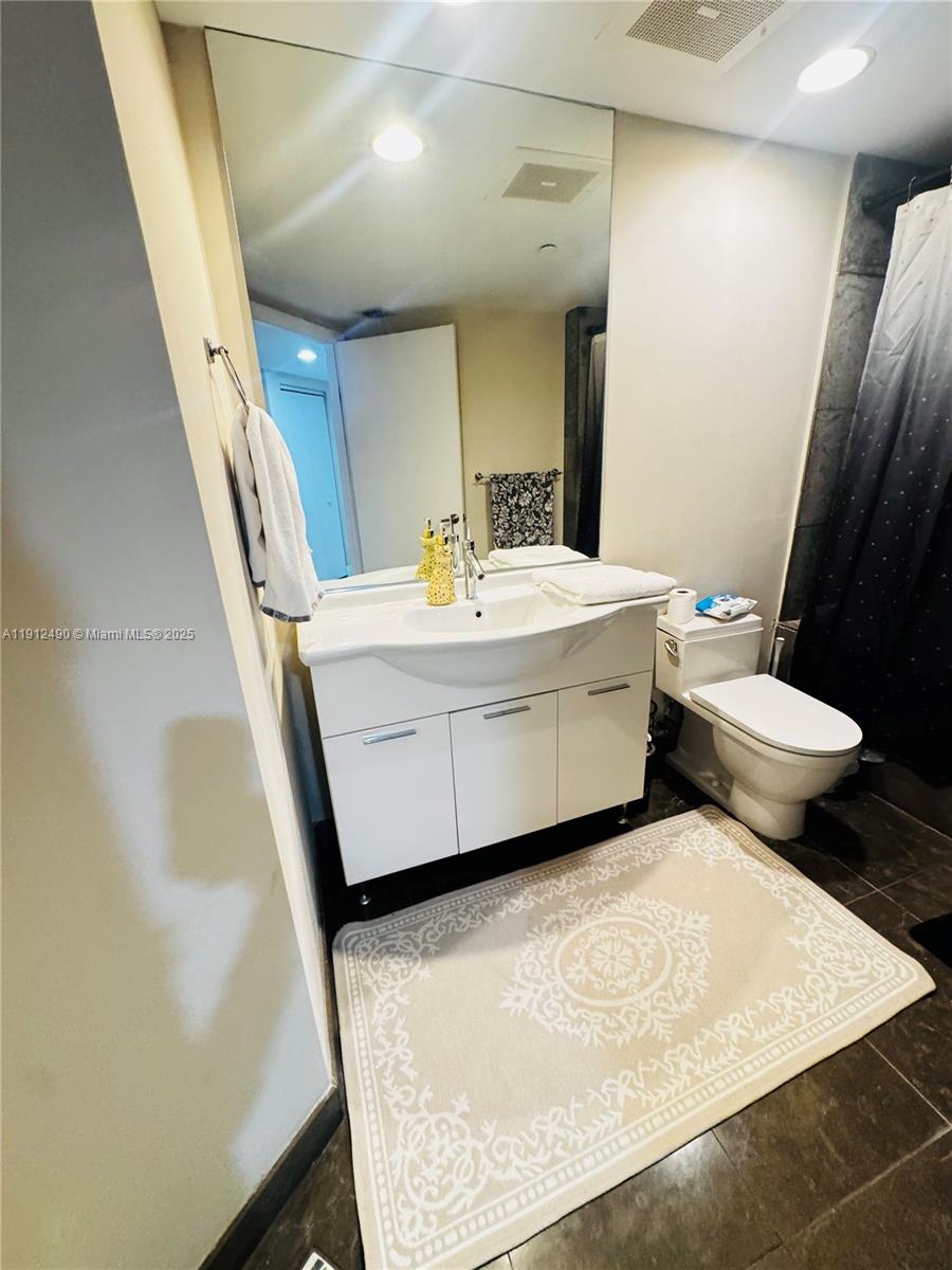 475 Brickell Avenue, Unit 808 Miami, FL 33131 - Photo 10 of 19 a bathroom with a sink and a mirror