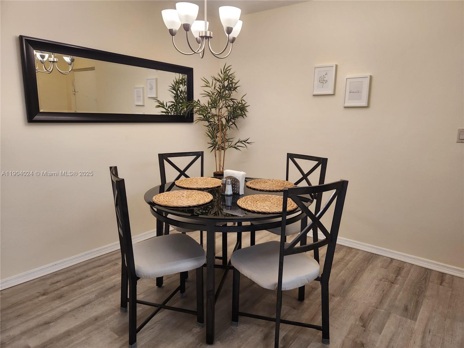 7300 Northwest 17th Street, Unit 220 Plantation, FL 33313 - Photo 11 of 27 a view of a dining room with furniture and wooden floor