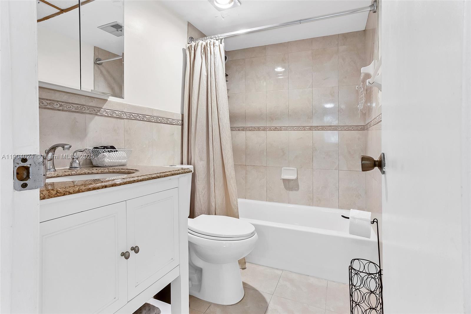 7300 Northwest 17th Street, Unit 220 Plantation, FL 33313 - Photo 19 of 27 a bathroom with a granite countertop sink toilet and shower