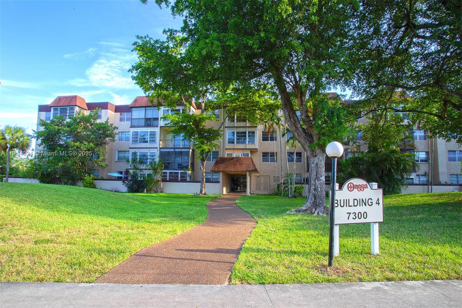 7300 Northwest 17th Street, Unit 220 Plantation, FL 33313 - Photo 2 of 27 a front view of a house with garden