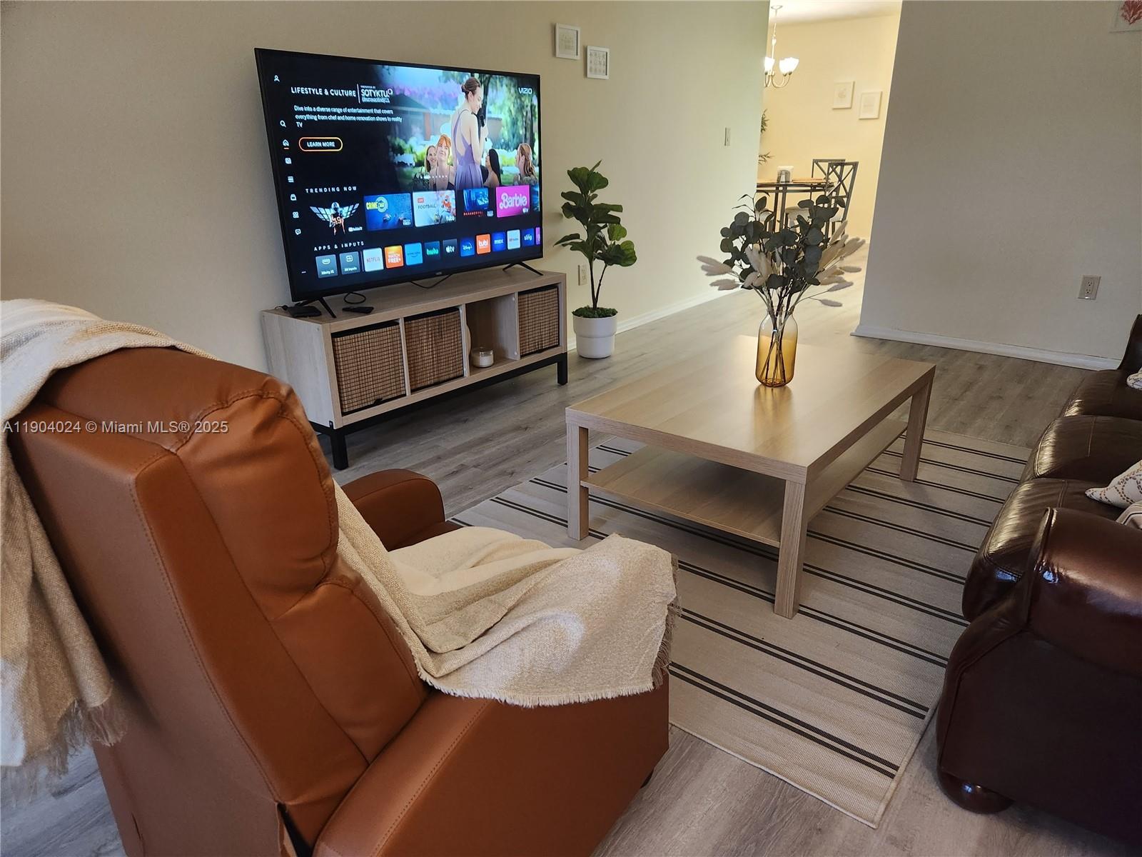 7300 Northwest 17th Street, Unit 220 Plantation, FL 33313 - Photo 5 of 27 a living room with furniture and a flat screen tv