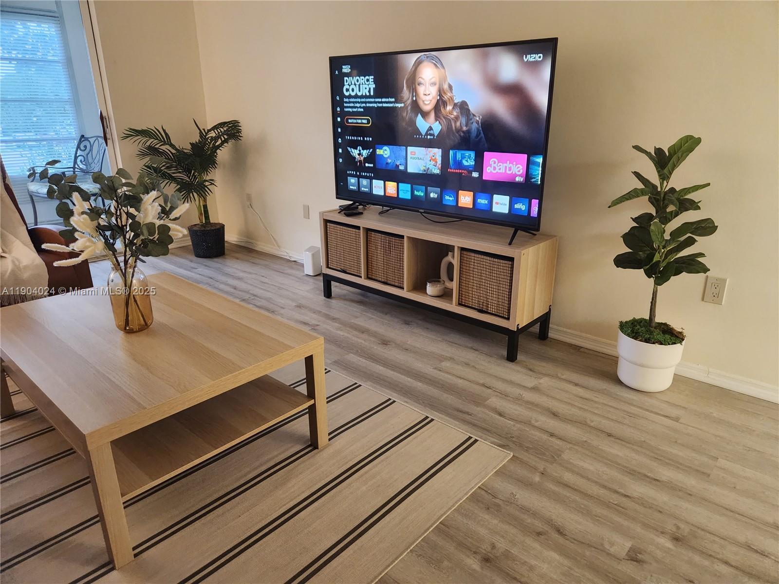 7300 Northwest 17th Street, Unit 220 Plantation, FL 33313 - Photo 6 of 27 a living room with furniture and flowers