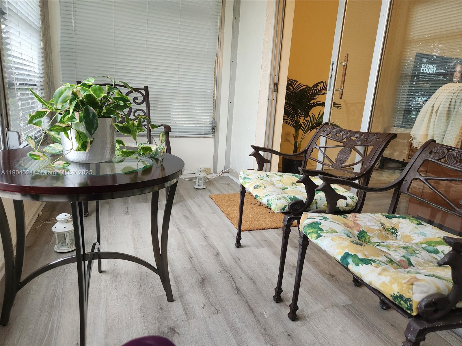 7300 Northwest 17th Street, Unit 220 Plantation, FL 33313 - Photo 9 of 27 a view of a dining room with furniture and a potted plant
