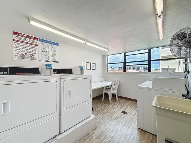 a view of a kitchen with appliances and wooden floor