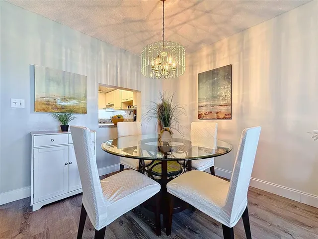 a view of a dining room with furniture and chandelier