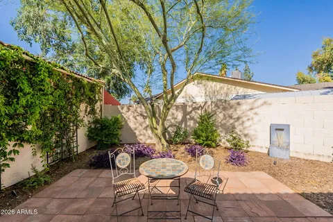 a view of a chair and table in backyard
