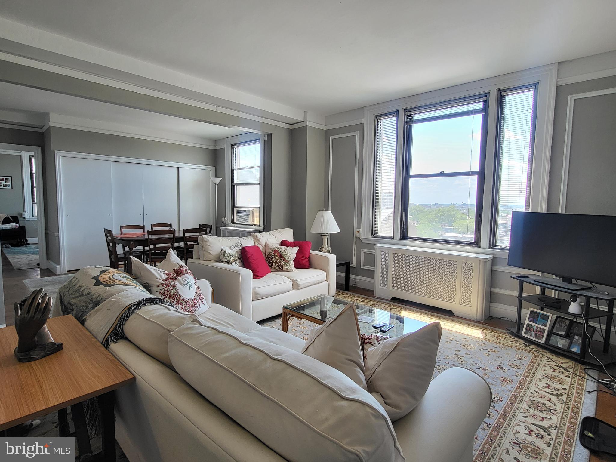 2031 Locust Street, Unit 801 Philadelphia, PA 19103 - Photo 1 of 23 a living room with furniture and a flat screen tv