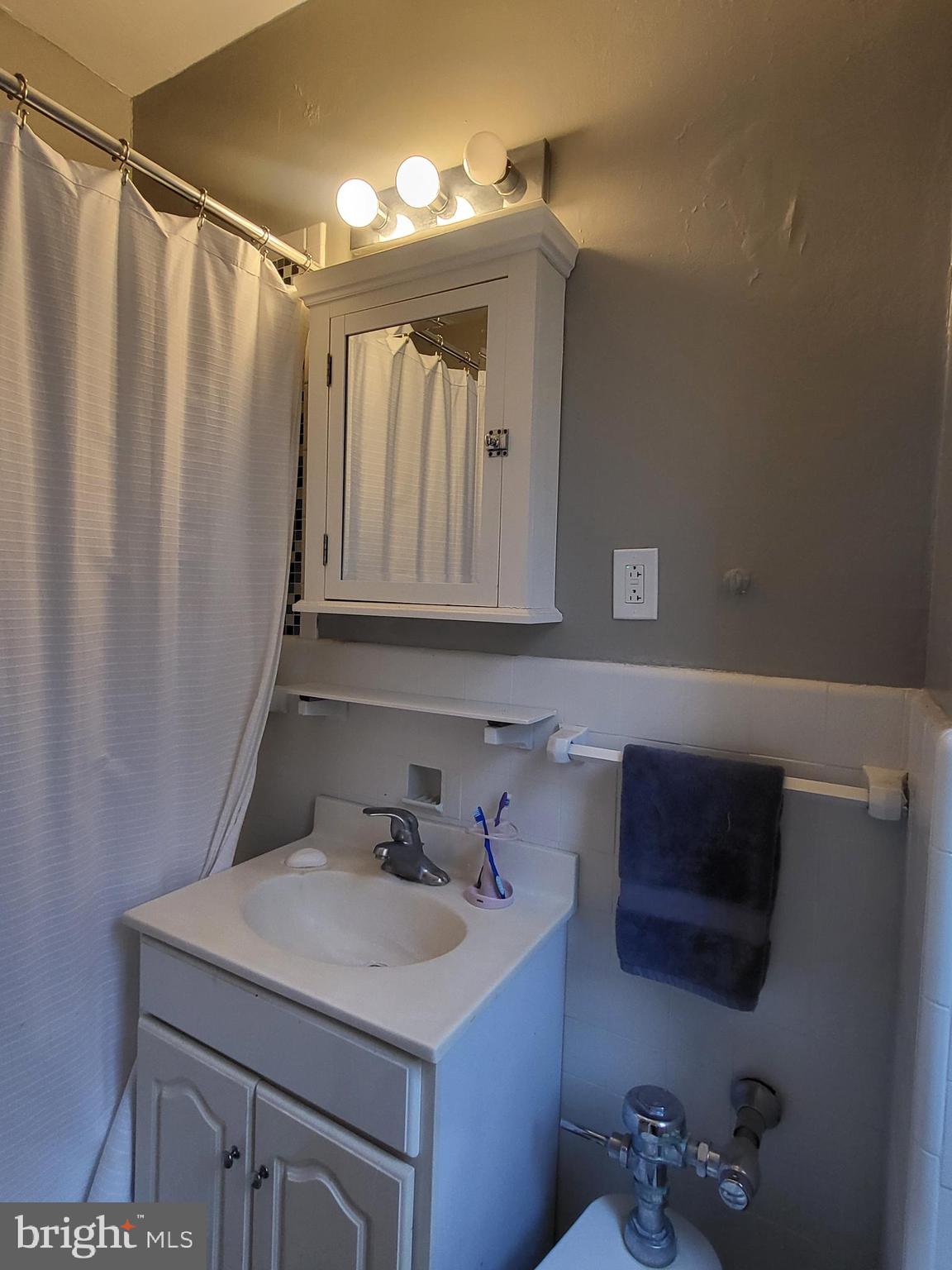 2031 Locust Street, Unit 801 Philadelphia, PA 19103 - Photo 11 of 23 a bathroom with a sink and a mirror