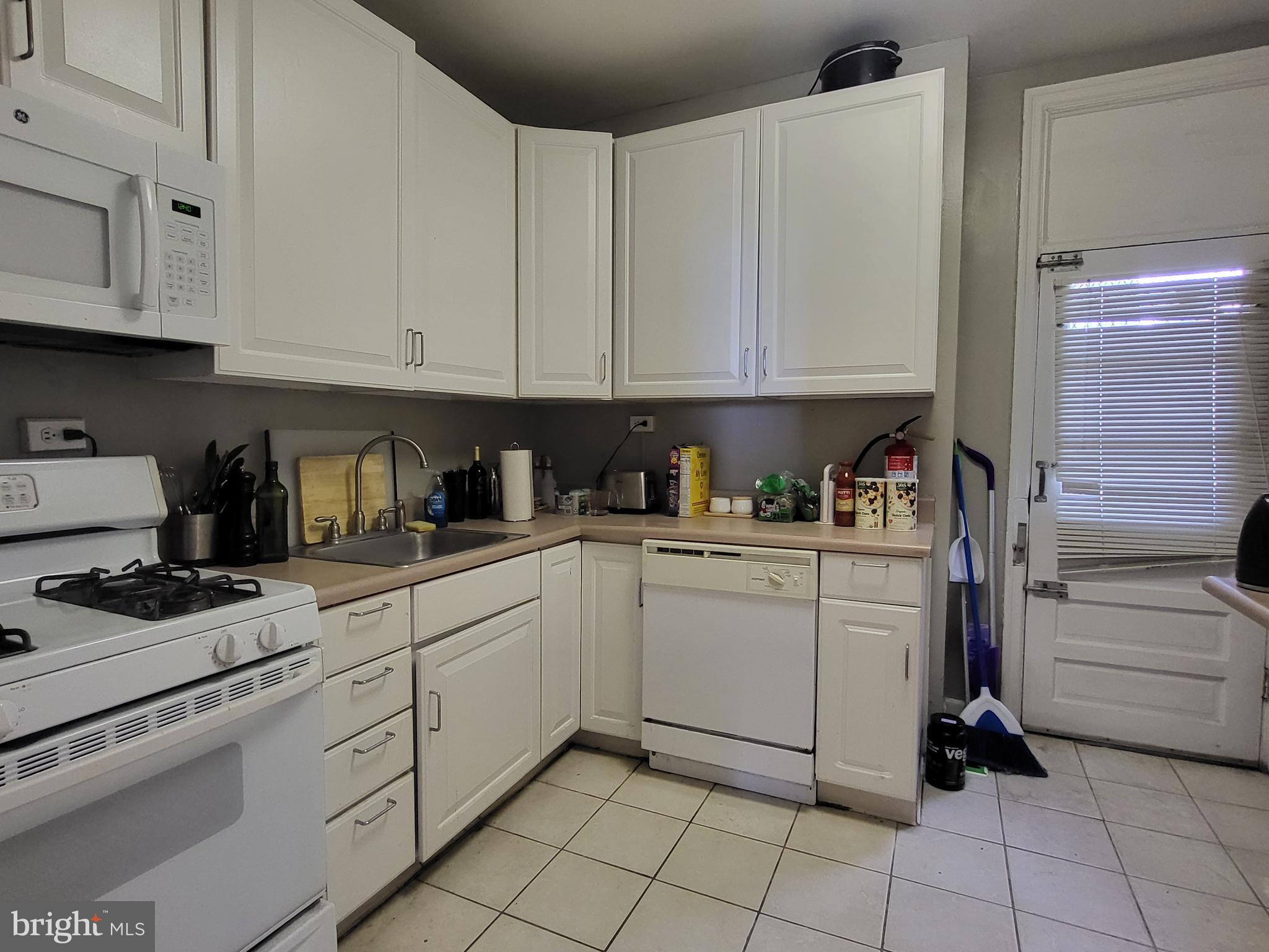 2031 Locust Street, Unit 801 Philadelphia, PA 19103 - Photo 7 of 23 a kitchen with white cabinets