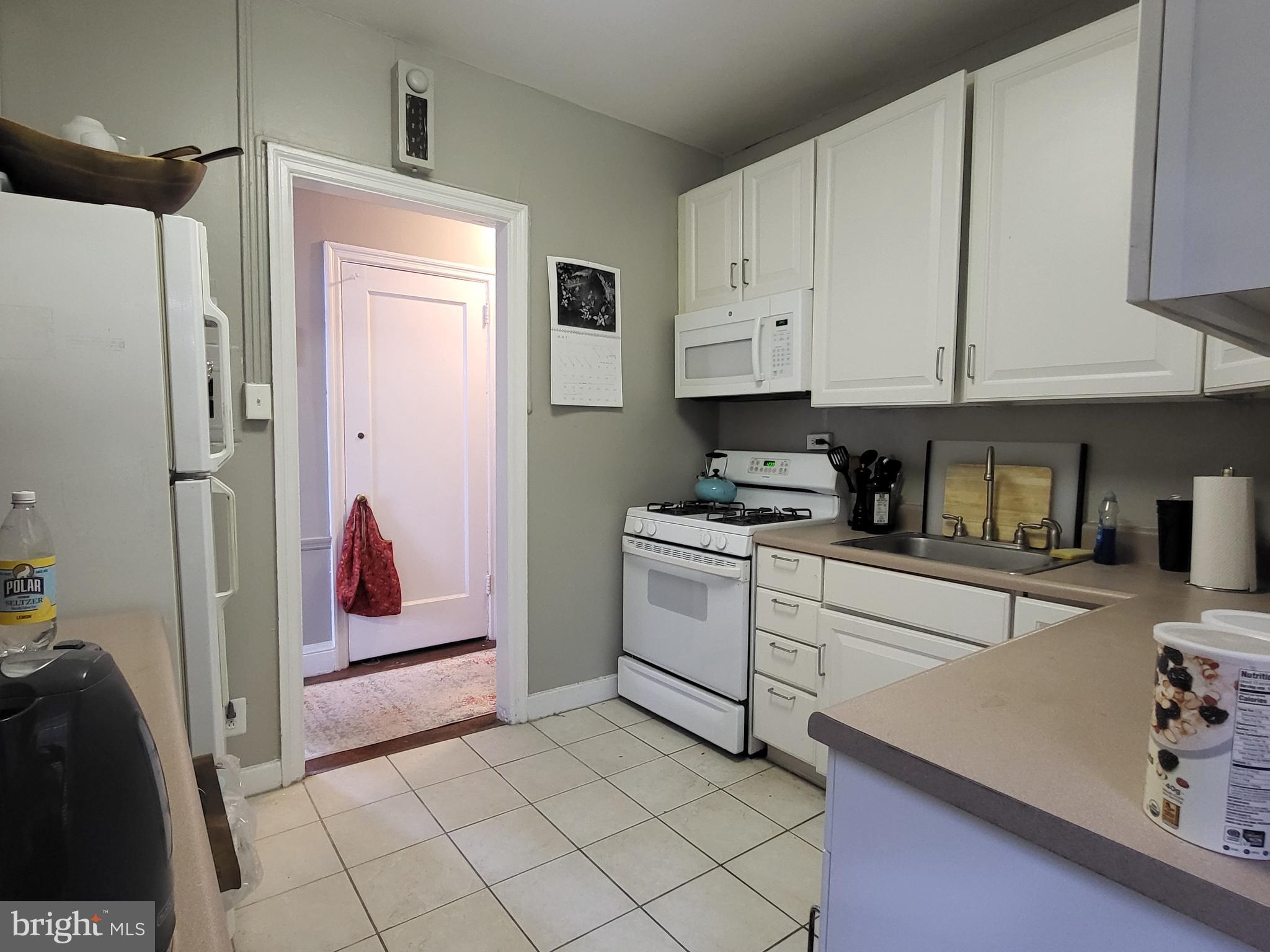 2031 Locust Street, Unit 801 Philadelphia, PA 19103 - Photo 8 of 23 a kitchen with cabinets and appliances