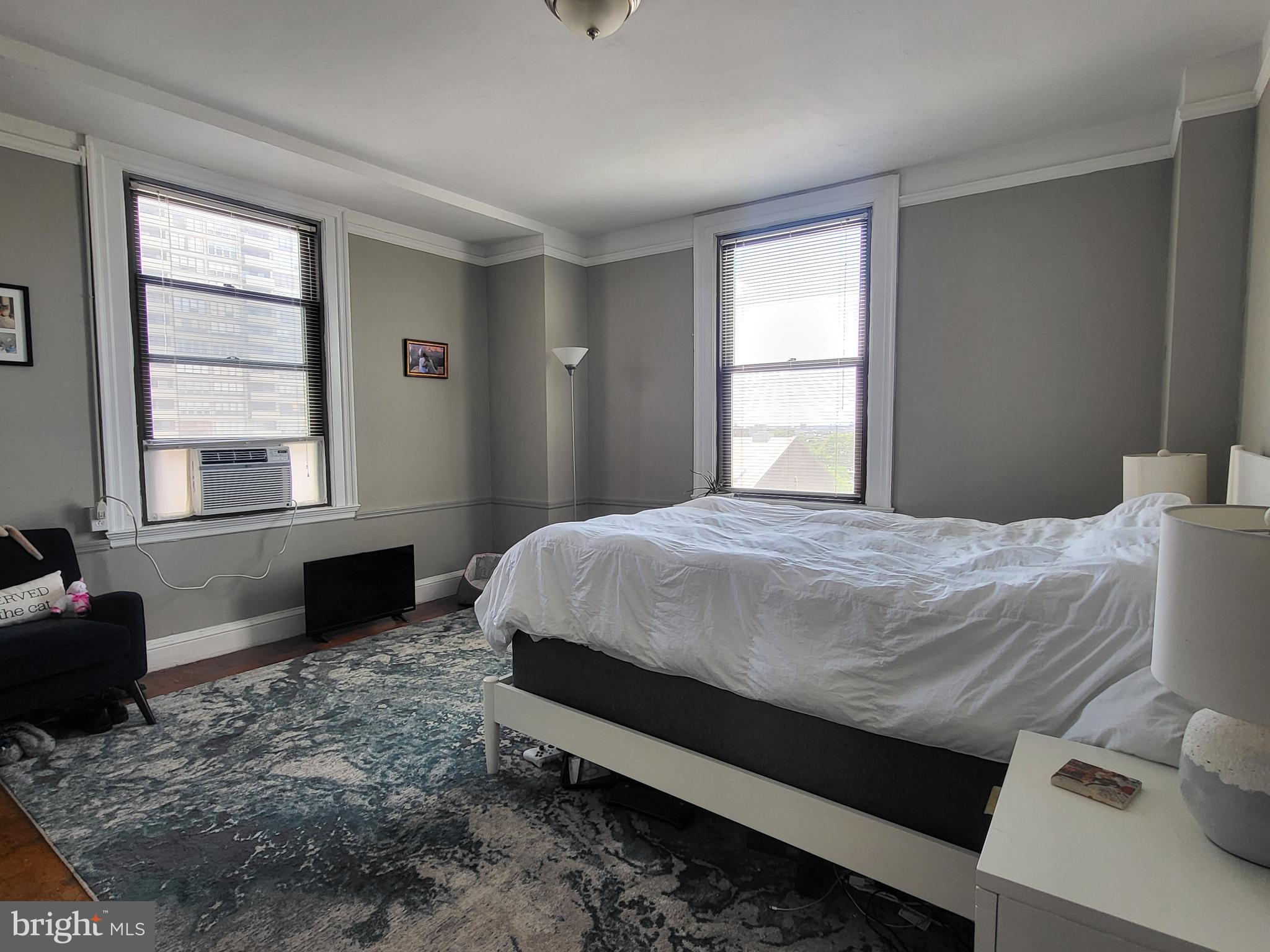 2031 Locust Street, Unit 801 Philadelphia, PA 19103 - Photo 9 of 23 a bedroom with a bed and wooden floor