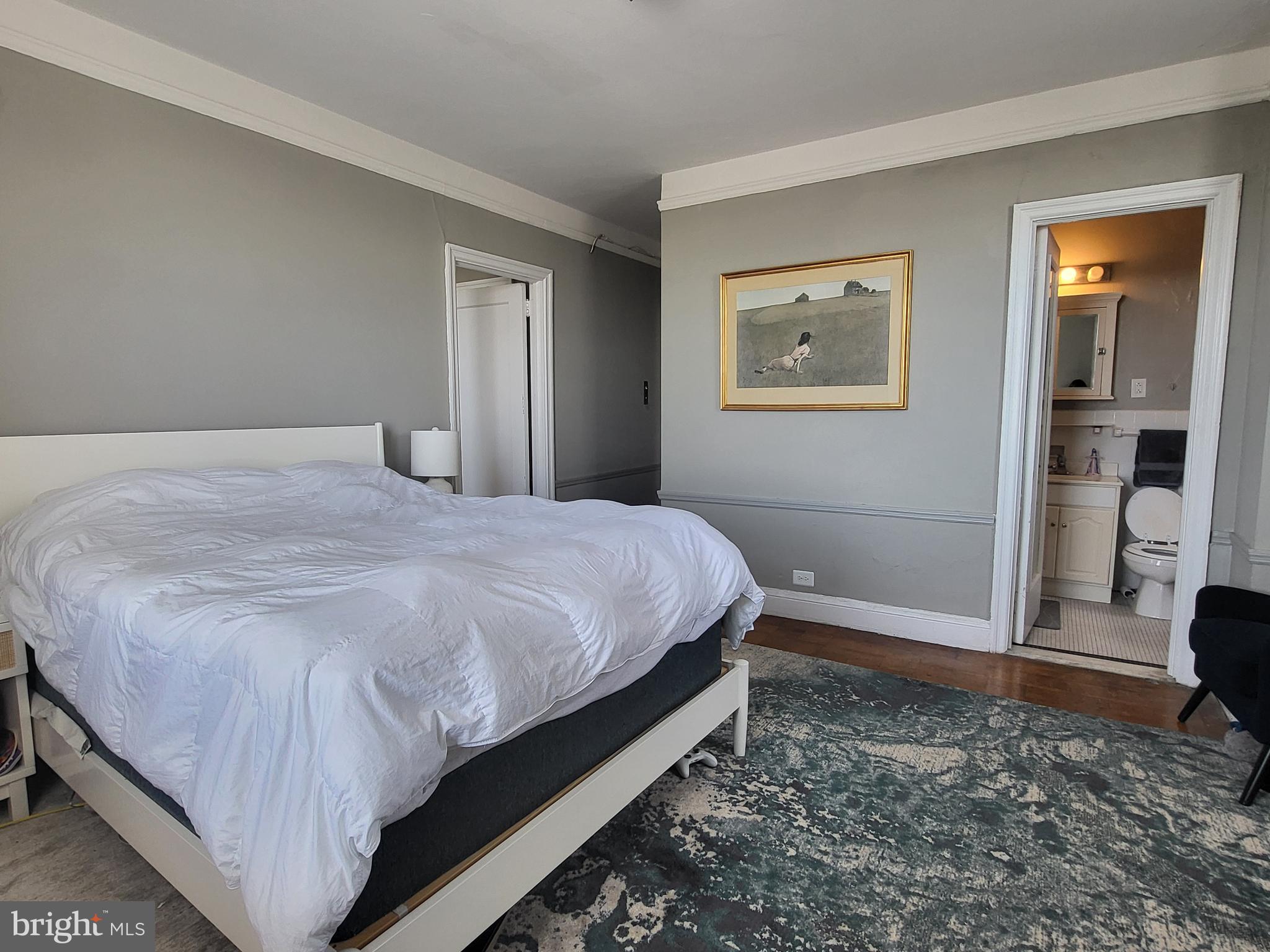 2031 Locust Street, Unit 801 Philadelphia, PA 19103 - Photo 10 of 23 a bed sitting in a spacious bedroom next to a window