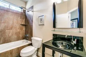 a bathroom with a sink a toilet and bathtub