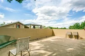 a terrace of a house with outdoor seating