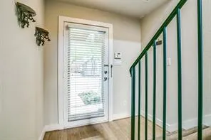 a view of an entryway with wooden floor