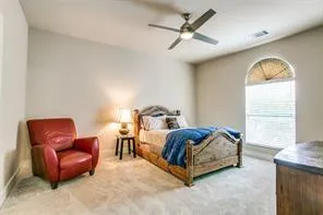 a living room with furniture a ceiling fan and a window