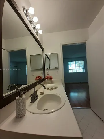 a bathroom with a sink and a mirror