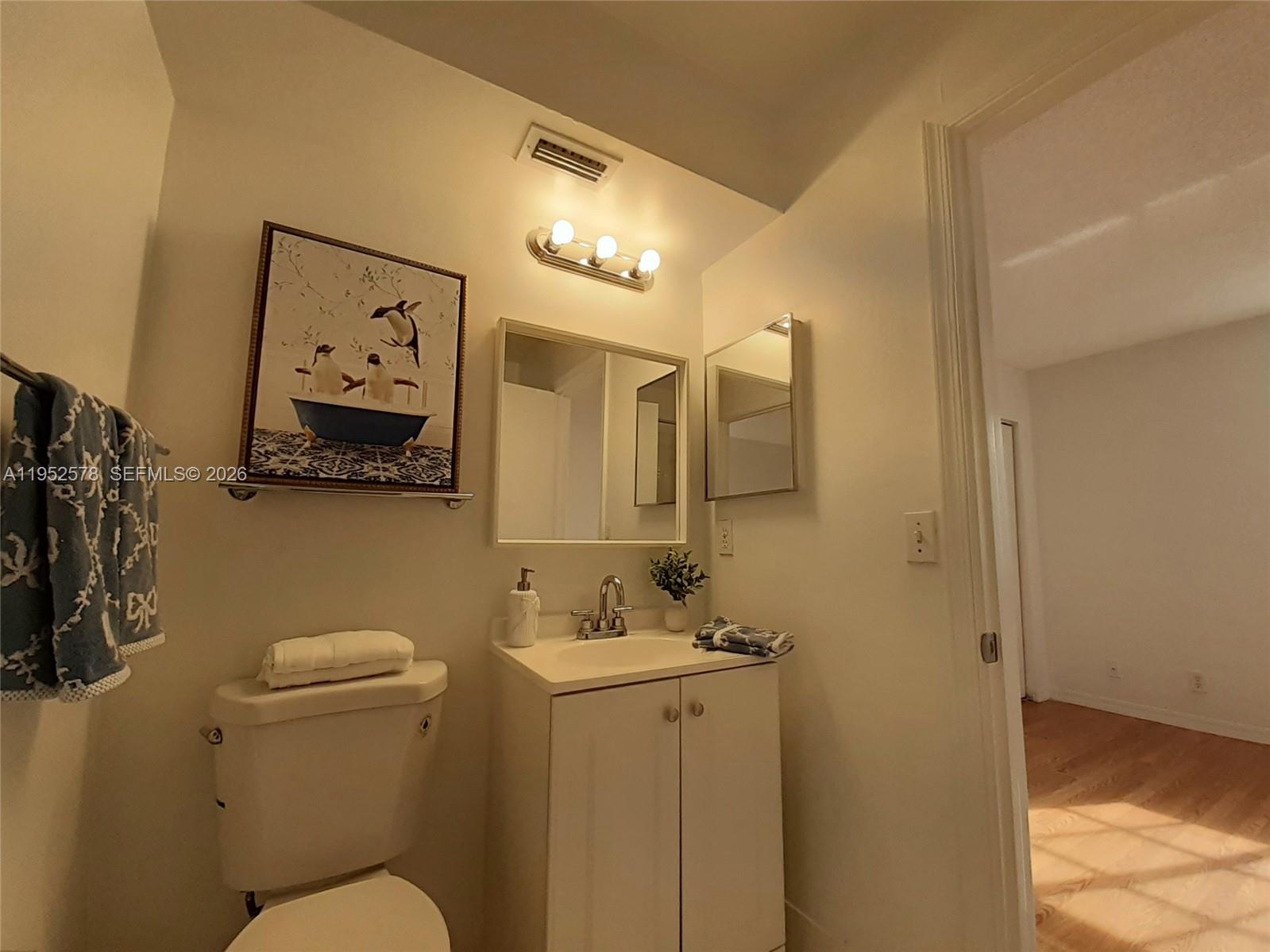 3618 San Simeon Circle, Unit 3618 Weston, FL 33331 - Photo 19 of 44 a bathroom with a toilet sink and mirror