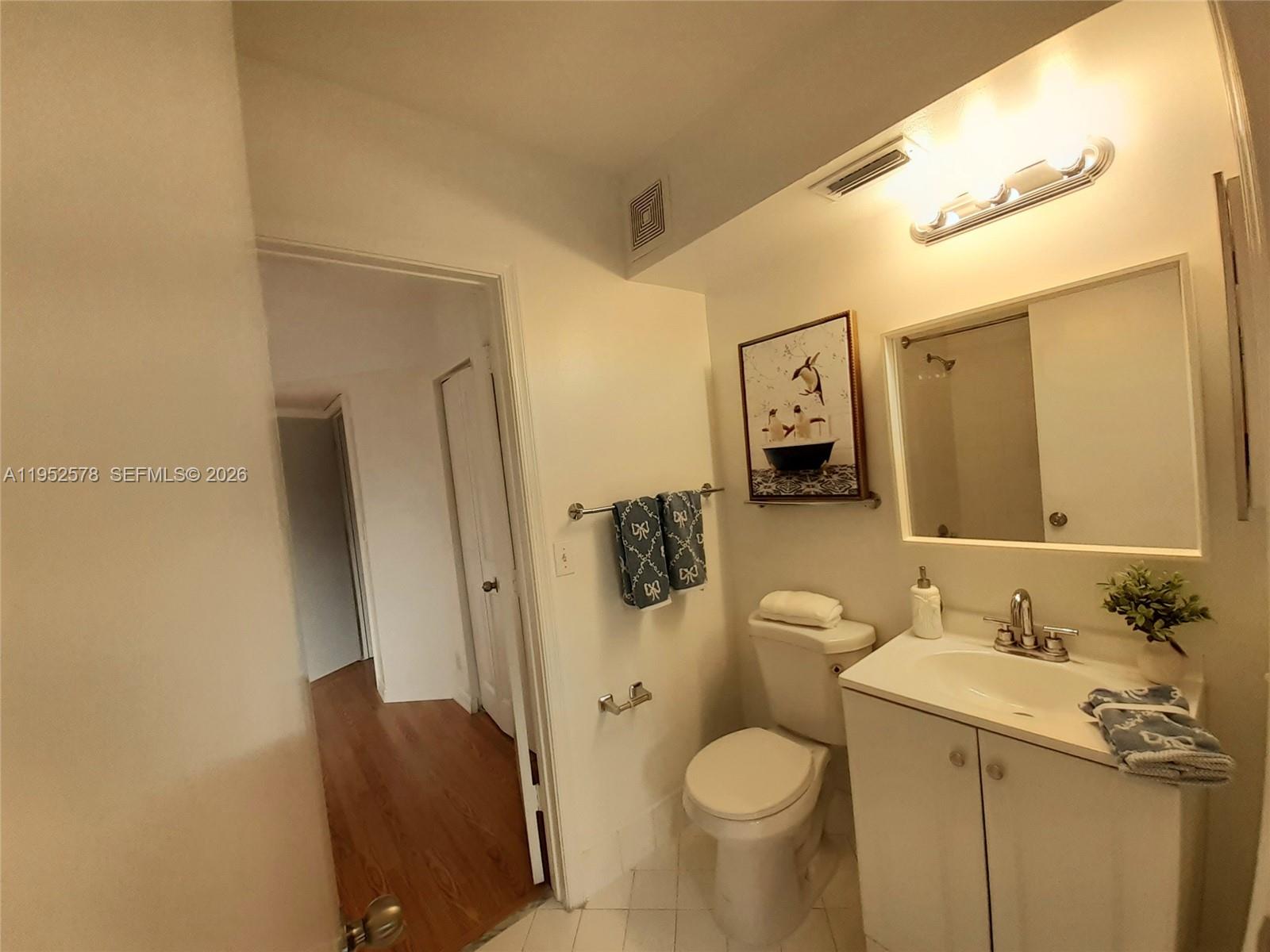 3618 San Simeon Circle, Unit 3618 Weston, FL 33331 - Photo 23 of 44 a bathroom with a granite countertop toilet sink and mirror
