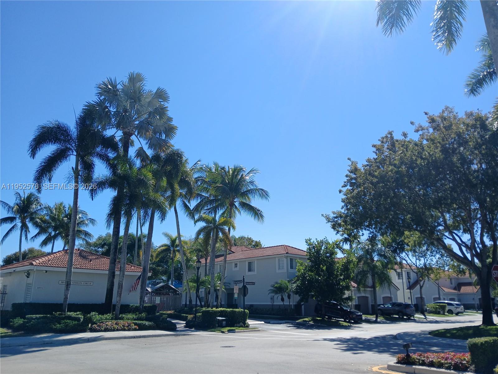 3618 San Simeon Circle, Unit 3618 Weston, FL 33331 - Photo 36 of 44 front view of a house with a yard and palm trees